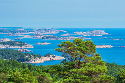 High angle view of townscape by sea against clear sky