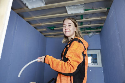 Young woman renovating house