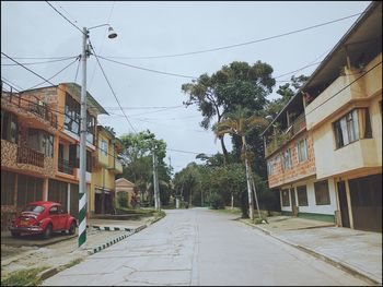 Street amidst buildings in city against sky