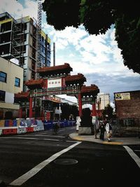 Vehicles on road against buildings in city