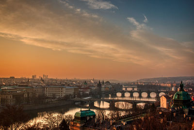 Prague bridges panorama during mist fog morning sunrise warm light red sky