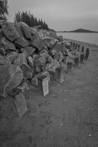 Stack of rocks on beach against sky