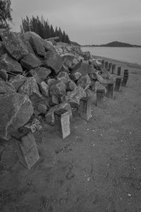 Stack of rocks on beach against sky