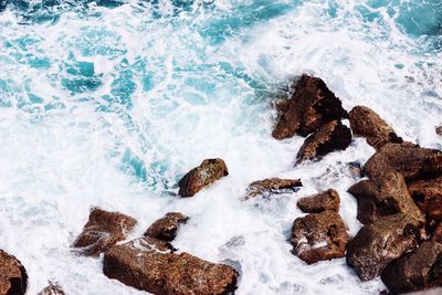 High angle view of rocks in sea