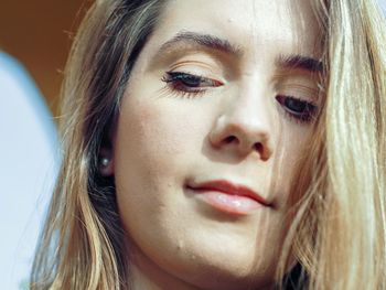 Close-up of beautiful young woman looking down