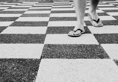 Low section of man walking on floor