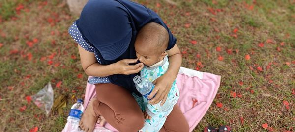 High angle view of mother and daughter on field