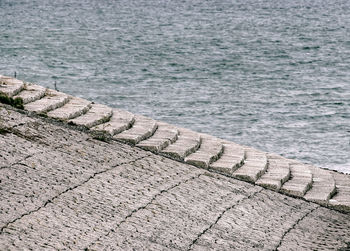 High angle view of footpath by sea