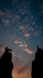 Low angle view of silhouette rocks against sky at sunset