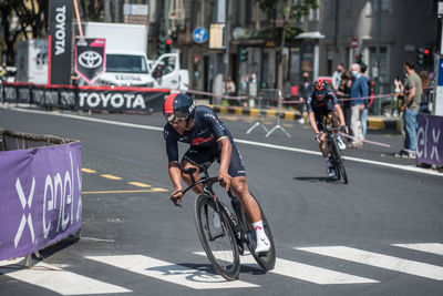 People riding bicycle on road