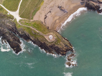 Above the lighthouse up in the sky looking down on the coastline