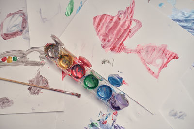 Children playing in an inner courtyard and painting with water paints