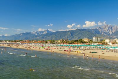 View of people on beach against sky