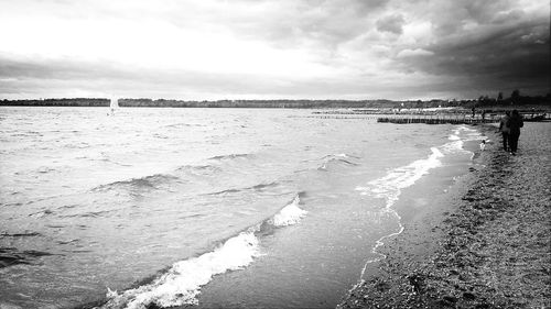 Scenic view of sea against cloudy sky