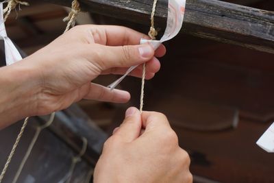 Cropped hand tying rope 