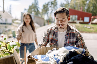 Man carrying cardboard box while moving in new house