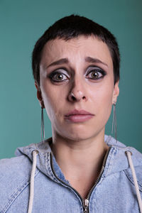 Portrait of young woman against clear sky