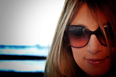 Close-up portrait of woman wearing sunglasses