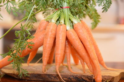 Close-up of tied up carrots on table