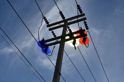 Low angle view of electricity pylon against sky