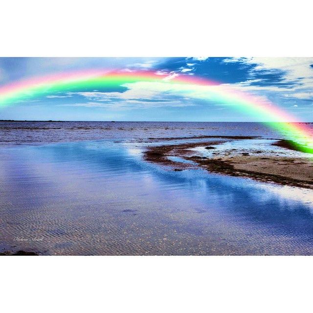 SCENIC VIEW OF SEA WITH RAINBOW IN BACKGROUND