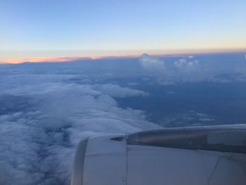 Low angle view of airplane flying over landscape