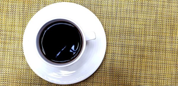 Directly above shot of coffee cup on table