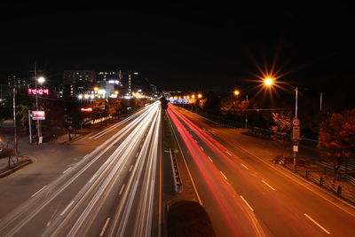 High angle view of light trails on road at night