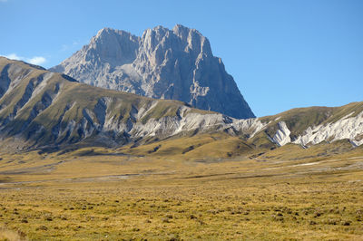 Scenic view of snowcapped mountains against clear sky