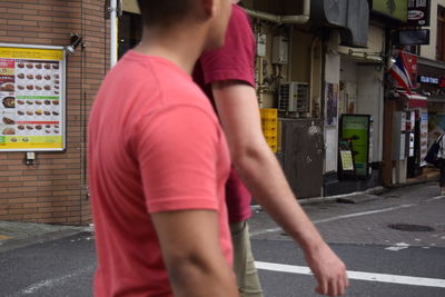 Rear view of man standing in city