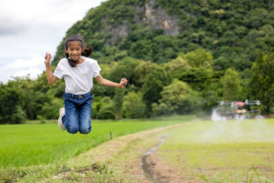 Full length of a boy jumping on grass