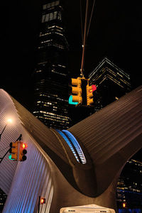 Low angle view of illuminated buildings against sky at night