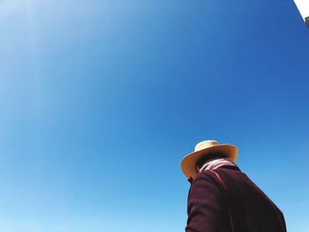 Rear view of man against clear blue sky