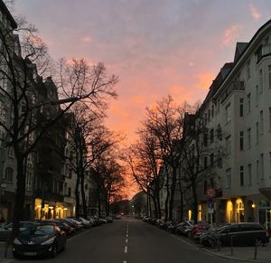 Cars moving on road at sunset