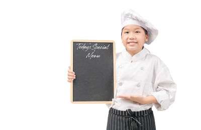 Portrait of smiling boy standing against white background