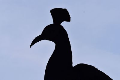 Low angle view of silhouette man against clear sky