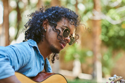 Portrait of young man sitting outdoors