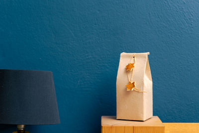 Close-up of stuffed toy against blue wall