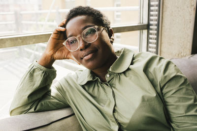 Businesswoman contemplating while sitting near window at office