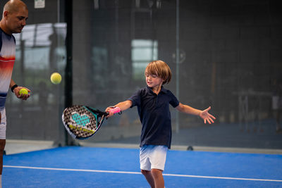 Full length of boy playing with ball