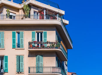 Low angle view of building against clear blue sky