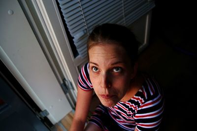 High angle view of thoughtful woman sitting at home
