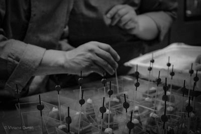 Midsection of male chefs preparing food in kitchen