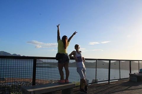 lifestyles, leisure activity, full length, sea, sky, water, standing, railing, young adult, casual clothing, young women, person, horizon over water, enjoyment, clear sky, three quarter length, sunlight