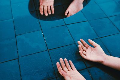 High angle view of people hands in swimming pool