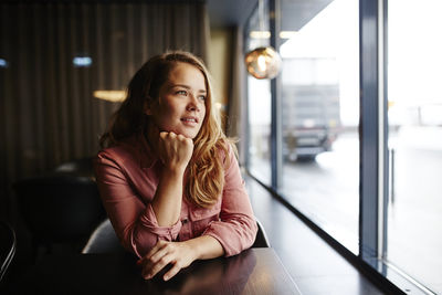 Woman looking through cafe window