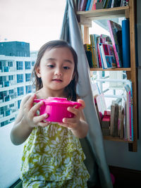 Portrait of cute girl in drinking glass