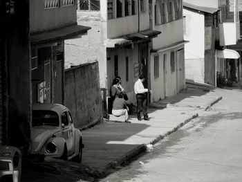 Rear view of people sitting in town square