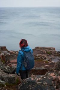 Rear view of man looking at sea shore