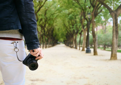 Rear view of man walking on footpath